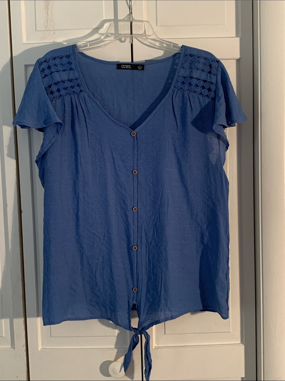 CURE. Flutter Sleeve Blue Button-Front Tie Hem Blouse